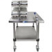 An Edlund Edvantage mobile can opening station on a stainless steel table with cans on it.