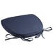 A navy blue Lancaster Table & Seating Chiavari chair cushion with ties.
