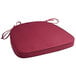 A Lancaster Table & Seating wine red Chiavari chair cushion with ties.