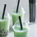 A group of green drinks with Choice black straws.
