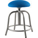 A National Public Seating cobalt blue stool with metal legs.