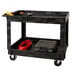 A black Rubbermaid utility cart with tools on it.