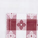A close-up of a red and white checkered fabric with a flannel back.