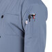 A person wearing a Uncommon Chef long sleeve chef coat with 10 buttons and a stethoscope in the pocket.