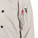 A white Uncommon Chef long sleeve chef coat with red buttons and a pocket.