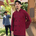 A man wearing a red Uncommon Chef Classic long sleeve chef coat with 10 buttons.
