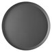 A close-up of a round black Vollrath pizza pan.