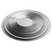 A close-up of a Vollrath wide rim aluminum pizza pan with a spiral design.
