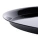 A close up of a WNA Comet black round catering tray with a high edge.