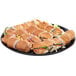 A plate of sandwiches on a black WNA Comet catering tray with high edges.