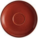 An Acopa Sedona Orange stoneware saucer with a speckled rim and a circle in the center.
