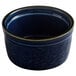 A close-up of an Acopa Azora Blue stoneware ramekin with a rim.