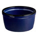 A blue stoneware ramekin with a black rim.