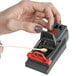 A person using a toothpick to set a Victor Pest Quick-Kill Mouse Trap.