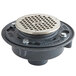 A Zurn black metal floor drain with a silver metal strainer cover.