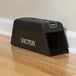 A Victor Pest black Smart-Kill electronic rat trap on a wood floor.