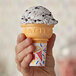 A hand holding a Keebler Eat-It-All cake cup filled with ice cream.