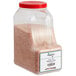 A plastic container of Regal Medium Grain Pink Himalayan Salt with a red lid.