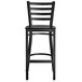 A Lancaster Table & Seating black metal ladder back bar stool with a black wood seat.