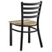 A Lancaster Table & Seating black metal ladder back chair with a driftwood seat.