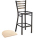 A black metal Lancaster Table & Seating ladder back bar stool with a natural wood seat.