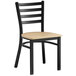 A Lancaster Table & Seating black metal ladder back chair with a natural wood seat.