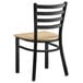 A black Lancaster Table & Seating ladder back chair with a natural wood seat.