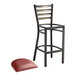 A Lancaster Table & Seating distressed copper metal bar stool with a round ladder back and a burgundy vinyl cushion.