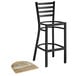 A Lancaster Table & Seating black metal bar stool with a driftwood seat.
