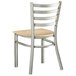 A Lancaster Table & Seating metal chair with a natural wood seat and ladder back.