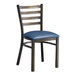 A Lancaster Table & Seating metal ladder back chair with a navy blue cushion.