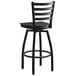 A Lancaster Table & Seating black ladder back swivel bar stool with a black wood seat.