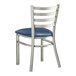 A Lancaster Table & Seating metal ladder back chair with a navy blue vinyl seat.