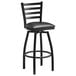 A Lancaster Table & Seating black ladder back swivel bar stool with a black cushion.