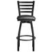 A Lancaster Table & Seating black finish ladder back swivel bar stool with a black padded seat.