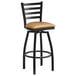 A Lancaster Table & Seating black ladder back bar stool with a light brown cushion.