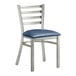 A Lancaster Table & Seating metal ladder back chair with navy blue vinyl cushion.