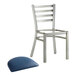 A silver metal Lancaster Table & Seating ladder back chair with a navy vinyl cushion.
