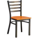 A Lancaster Table & Seating ladder back chair with a wooden seat and black frame.