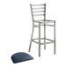 A Lancaster Table & Seating metal bar stool with navy blue vinyl padded seat.