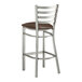A Lancaster Table & Seating metal ladder back bar stool with a dark brown vinyl padded seat.