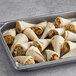 A tray of Les Chateaux de France Chicken Cornucopia Cone Quesadillas filled with meat and cheese.