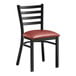 A Lancaster Table & Seating black metal ladder back chair with a burgundy vinyl padded seat.