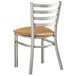 A Lancaster Table & Seating metal restaurant chair with a light brown vinyl padded seat and ladder back.