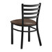 A Lancaster Table & Seating black metal ladder back chair with a dark brown vinyl padded seat.