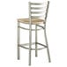 A Lancaster Table & Seating metal bar stool with a wooden seat and clear coat finish.