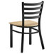 A Lancaster Table & Seating black metal chair with a natural wood seat.