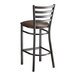 A Lancaster Table & Seating metal bar stool with a dark brown vinyl padded seat.