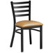 A black Lancaster Table & Seating chair with a light brown padded seat and wooden ladder back.