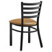 A black Lancaster Table & Seating metal chair with a light brown cushion.